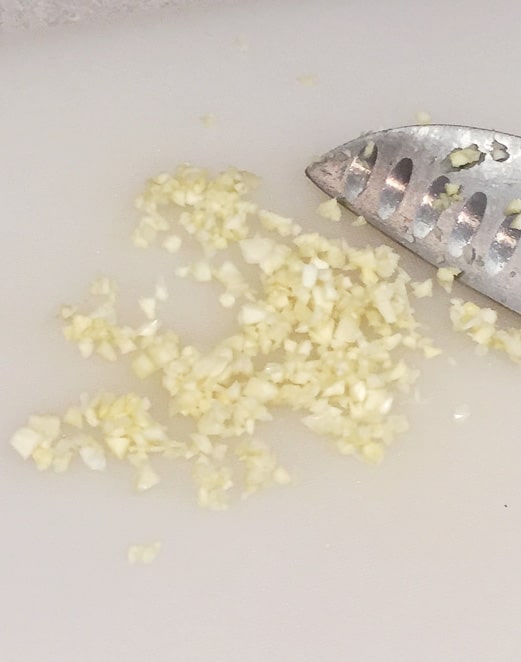 chopping garlic for vegan general tso tofu recipe