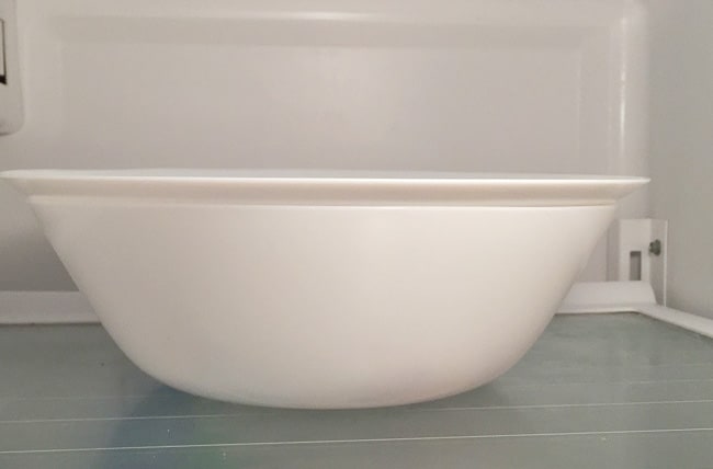 a bowl in the fridge containing the tofu to be marinated.