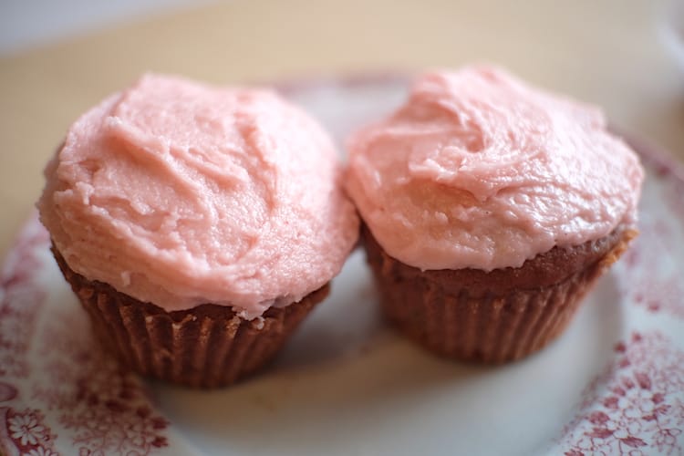 Vegan strawberry icing on vegan strawberry cupcakes made from scratch.