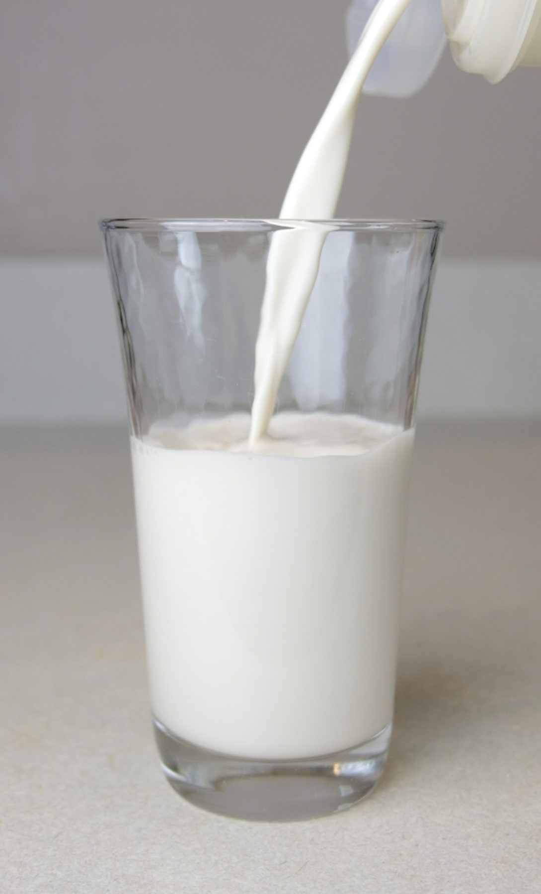 Almond milk being poured into a glass