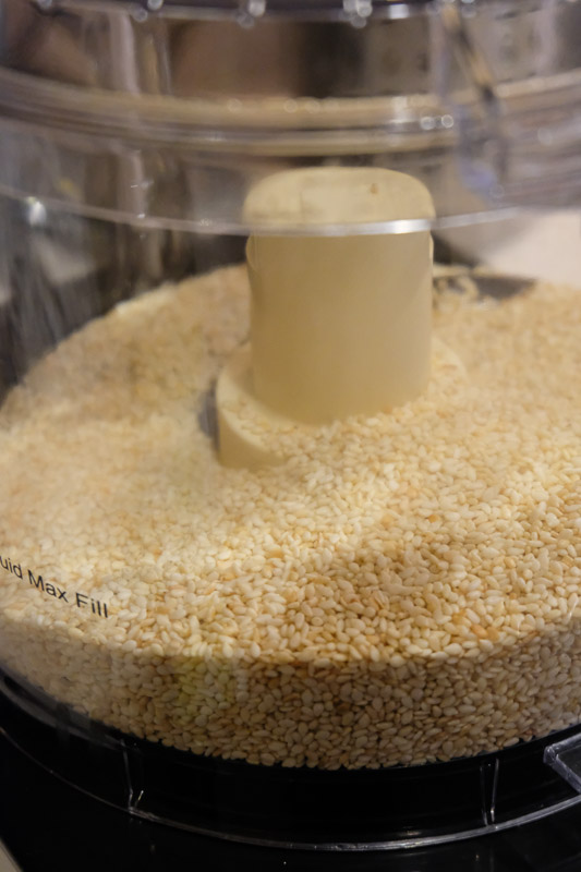 the toasted sesame seeds are added into a food processor.