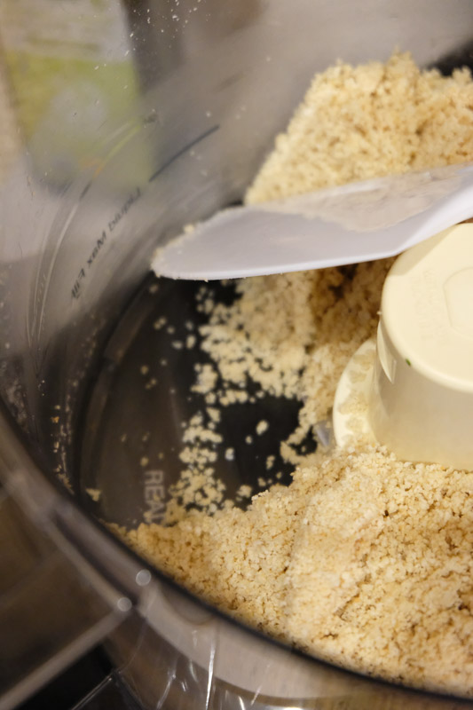 After processing the toasted sesame seeds in the food processor, stop the machine and scrape down the bottom and sides with a spatula to catch any whole seeds that have been stuck there.