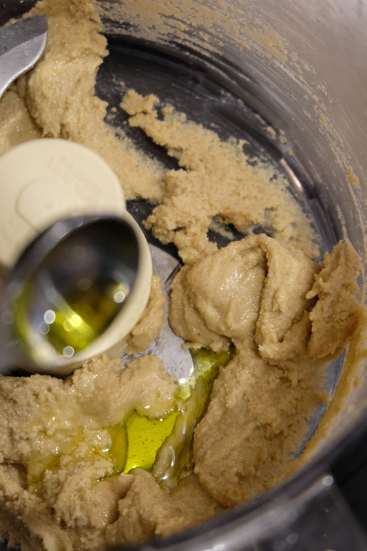 Scrape down the sides and bottom of the food processor again and add more olive oil.