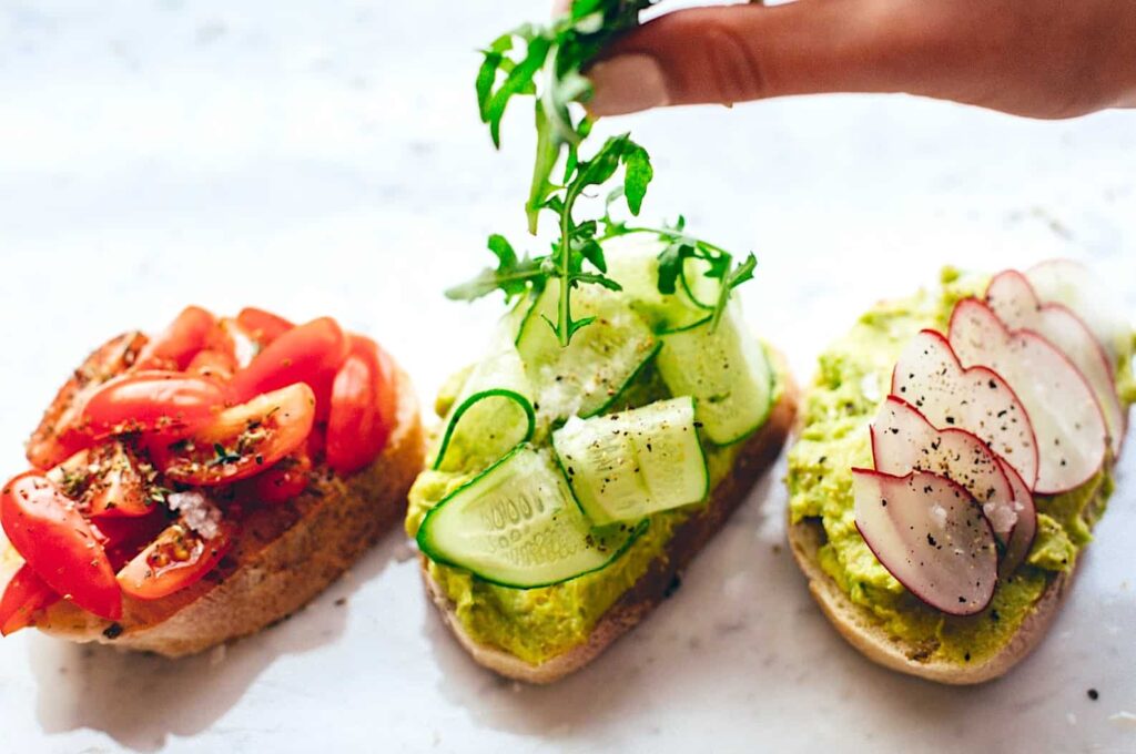Three avocado toast toppings - tomato, cucumber, and beet.