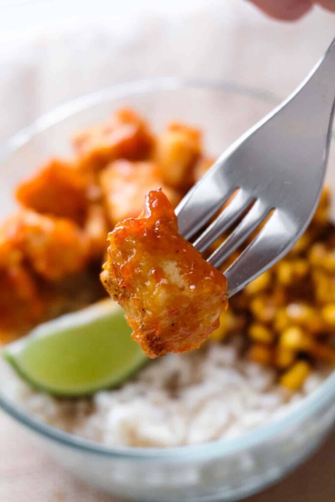 close up view of a piece of chipotle lime tofu on a fork.