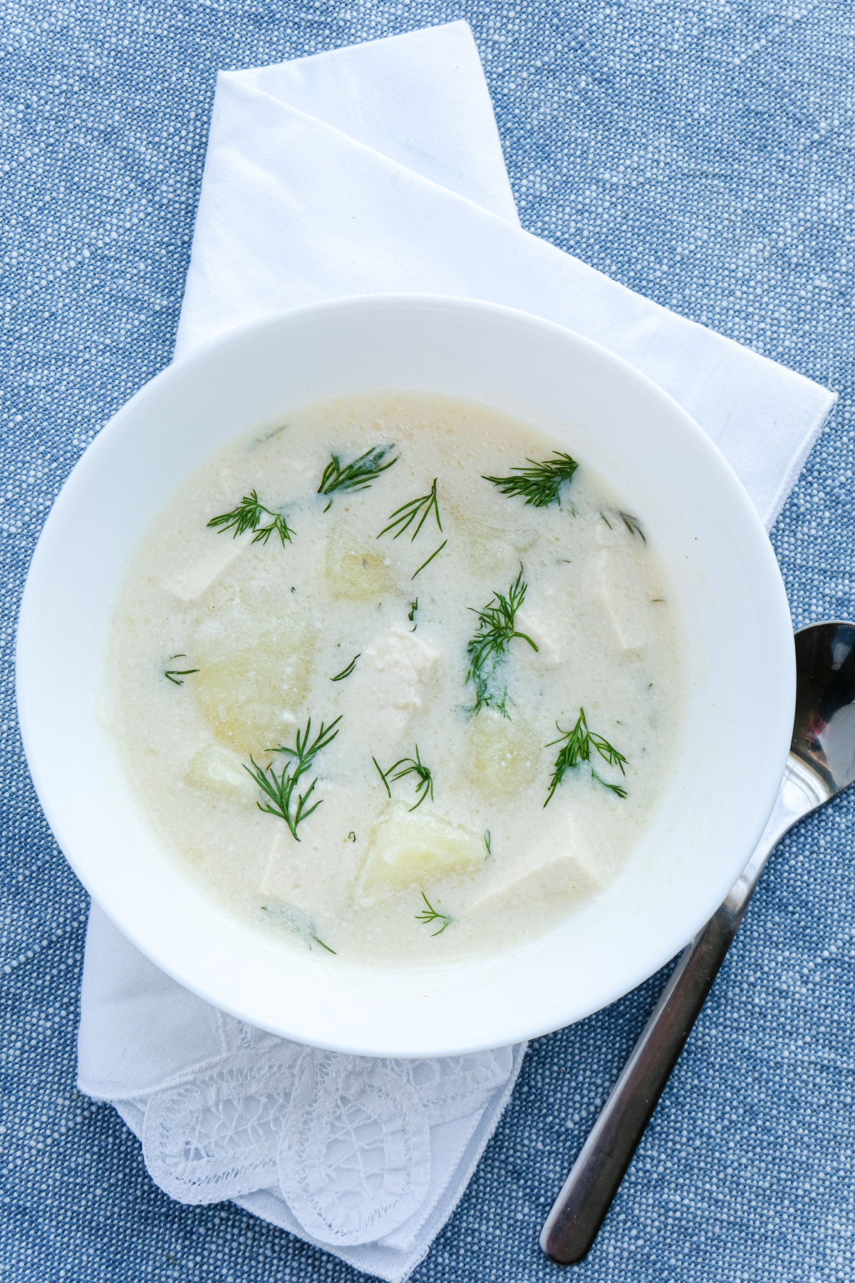 A bowl of vegan potato cream soup with dill